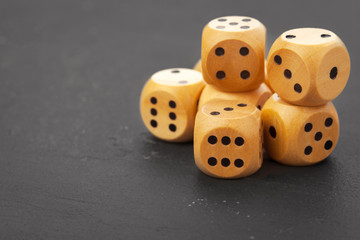 Rolling dice on a wooden desk
