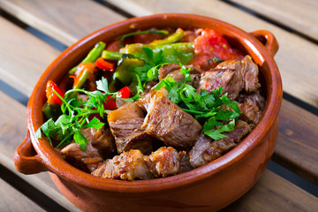 Tasty dish ghiveci of bulgarian cuisine of beef  with paprika  at clay pot