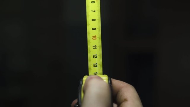 the guy reveals a measuring building ruler
