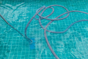 Swimming pool cleaning progress, vacuum hose , pool service