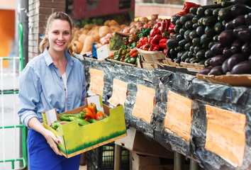 Woman with vegetarian box in market