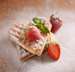 heart-shaped cookies, strawberries, mint and powdered sugar
