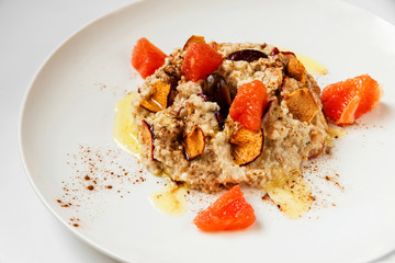 Oatmel porridge with fruit, closeup.