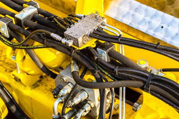 Close up of pipe system of hydraulic valves in agricultural machinery