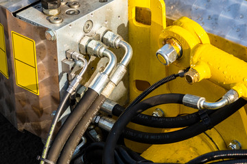 Close up of pipe system of hydraulic valves in agricultural machinery