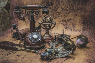Antique Telephone And Old Collection On Old World Map
