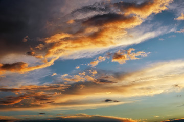 Beautiful dark fluffy cloudy sky. Sunset light.