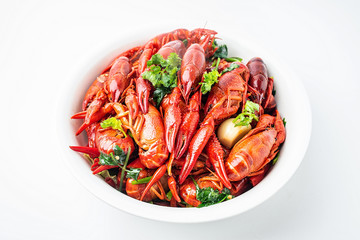 A large bowl of bright red delicious braised crayfish on a white background