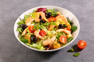 shrimp salad in bowl with tomato and lettuce