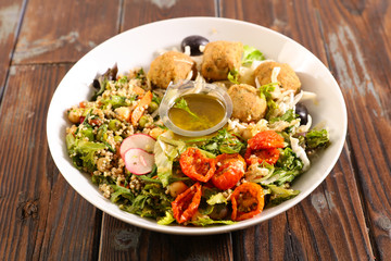 buddha bowl with chickpea, tomato, falafel and sauce