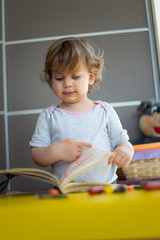 toddler girl drawing with crayons on paper