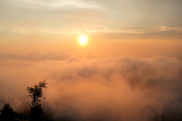 Beautiful structure of clouds on sky, mountain landscape with dense fog at sunset on horizon of beauty natural environment. Panorama of amazing sunrise view show sun rays through clouds over mountain.