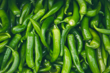 Fresh hot green chilli pepppers in the market as a food background