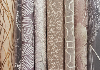 Samples of curtains in beige-brown palette. Background and texture of beige fabric for curtains.