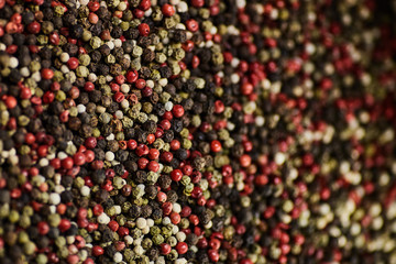 black, white, red peppercorns spice. Closeup Background