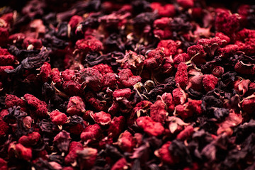 Flower tea made from pink petals and pomegranate flowers. Closeup background