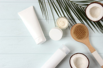 Coconut, tropical leaf and care products on a colored background top view. Cosmetics with coconut extract for hair, body, face. Skin care, skin hydration. flatlay