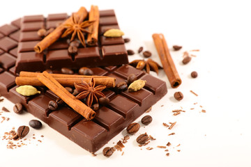 chocolate bar and spices on white background