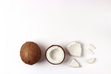 Fototapeta na wymiar broken coconut on a white background top view.
