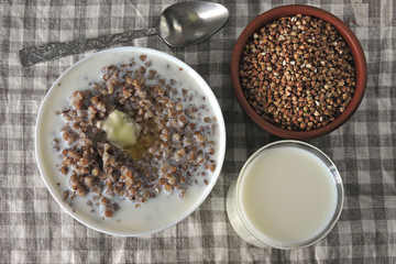 Buckwheat porridge with milk and butter. Healthy breakfast or snack. Dietary food.
