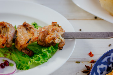 Fresh barbecue meat on white plate.