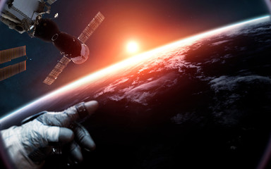 Astronaut at the international space station orbiting Earth planet. Elements of this image furnished by NASA
