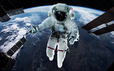 Naklejka premium Astronaut at the Earth planet orbit. Awesome science fiction render. Elements of this image furnished by NASA