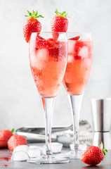 Rossini alcoholic cocktail with Italian sparkling wine, strawberry puree and ice in champagne...