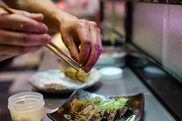 preparation of japanese food including sushi and salad