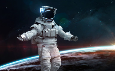 Astronaut at Earth orbit. Science fiction wallpaper. Elements of this image furnished by NASA