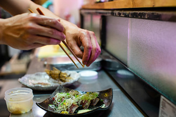 preparation of japanese food including sushi and salad