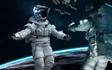Naklejka premium Astronaut at Earth orbit. Science fiction wallpaper. Elements of this image furnished by NASA
