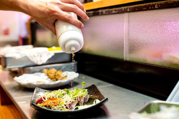 preparation of japanese food including sushi and salad