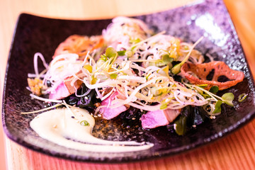 preparation of japanese food including sushi and salad