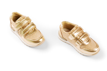 flat lay. the gold children's sports shoes isolated on a white background