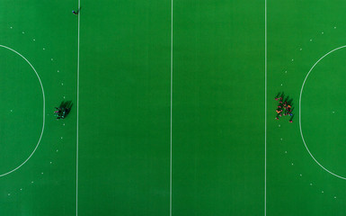 Conference during break time in hockey on the grass match. Top view.