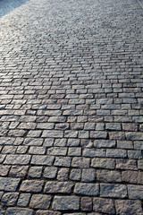 Stone paving stone in the light of the sunrise in Prague