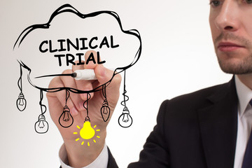 Business, technology, internet and networking concept. Young entrepreneur showing keyword: Clinical trial