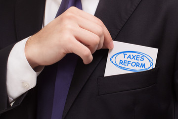 Business, technology, internet and networking concept. Young entrepreneur showing keyword: taxes...