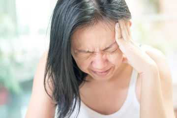 Brain diseases problem cause chronic severe headache migraine. Female adult look tired and stressed...