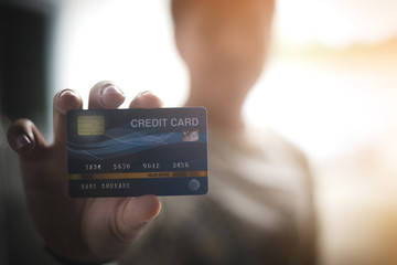 Hands holding plastic credit card for pay. This is Shopping concept