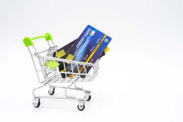 money concept of Credit Cards in a Shopping Cart on isolate white background.  as background business concept and Saving concept with  copy space for your text or design.