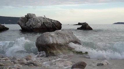 The waves of the Adriatic Sea are crushing on the stones on the beach