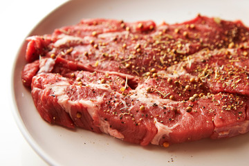 Fresh raw seasoned beef on plate