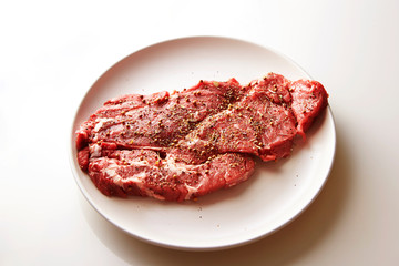 Fresh raw seasoned beef on plate