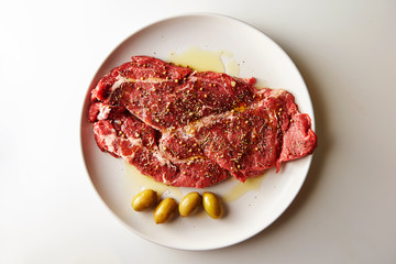 Fresh raw seasoned beef with olive oil