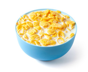 Cornflakes dry breakfast with milk. The blue plate is full of cereal and milk. Isolated on white background.