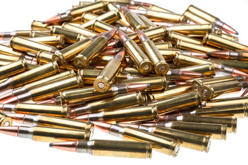 cartridges for 308 caliber rifle on a white background. a bunch of ammo. cartridges scattered on a light background