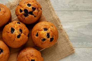 Muffins with raisins on the table. Muffins on a cutting board on the kitchen table. View from above. A lot of delicious cupcakes. Baking with raisins for breakfast.