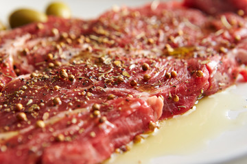 Fresh raw seasoned beef with olive oil